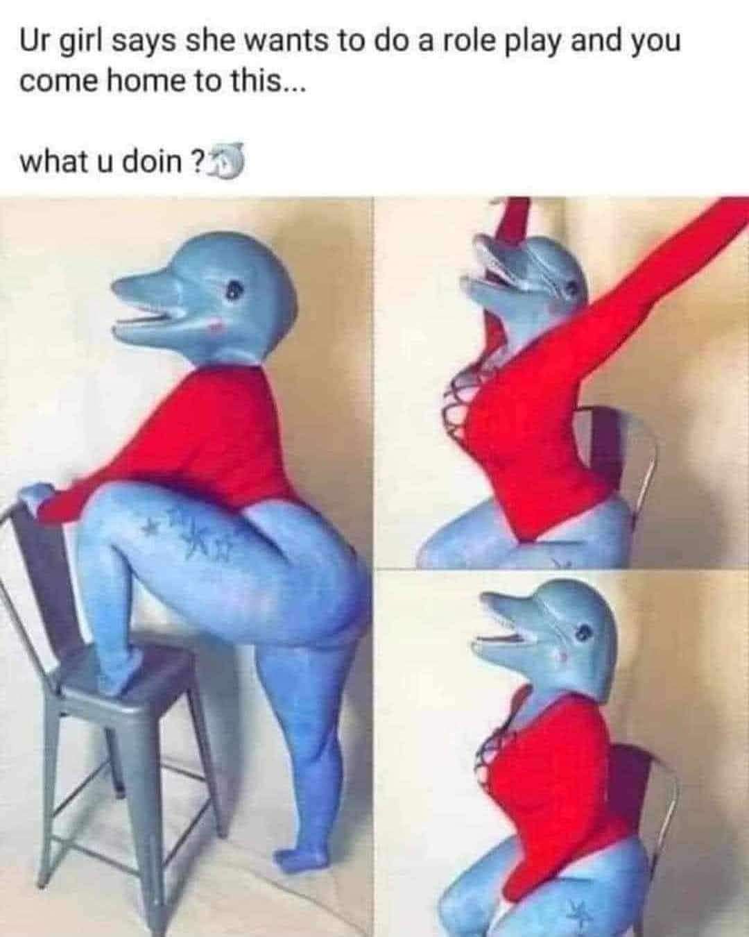 A feminine-presenting person in blue body paint, sexy red bodysuit, and a surprisingly realistic dolphin head to complete the costume. Above caption reads "Ur girl says she wants to do a role play and you come home to this… what u doin'?"